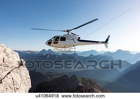 Helicopter transporting BASE jumpers to summit, Dolomites, Italy View Large Photo Image Stock Photo - Helicopter transporting BASE jumpers to summit, Dolomites, Italy. Fotosearch