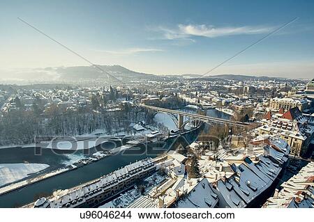 Picture - High angle view of river Aare and city with snow covered rooftops, Berne, Switzerland. Fotosearch