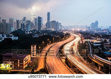Stock Image - Highway with light trails and skyline at dusk, Kuala Lumpur, Malaysia. Fotosearch