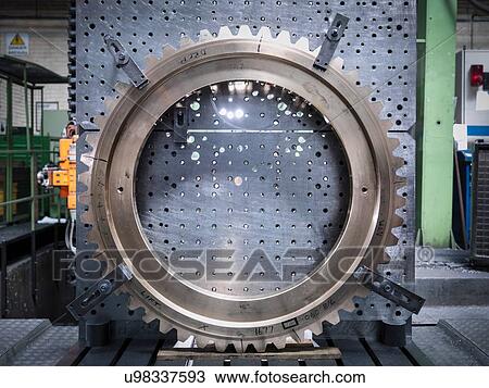 Stock Image - Lathe gear wheel on lathe in engineering factory. Fotosearch