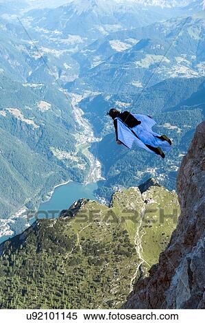 Male BASE jumper wingsuit flying over valley, Dolomites, Italy View Large Photo Image Stock Photography - Male BASE jumper wingsuit flying over valley, Dolomites, Italy. Fotosearch