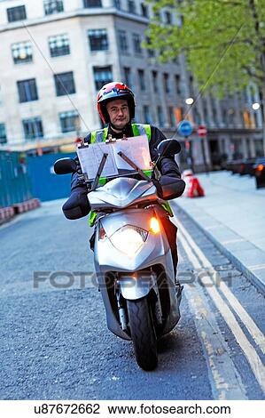 Male motor scooter rider indicating View Large Photo Image Stock Image - Male motor scooter rider indicating. Fotosearch
