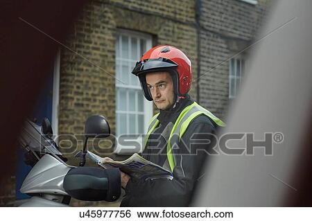 Male motor scooter rider reading London street map View Large Photo Image Stock Photograph - Male motor scooter rider reading London street map. Fotosearch