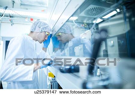 Male scientist monitoring fume hood test in lab cleanroom View Large Photo Image Stock Photo - Male scientist monitoring fume hood test in lab cleanroom. Fotosearch