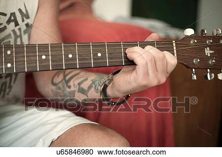 Stock Image - Man playing guitar. Fotosearch