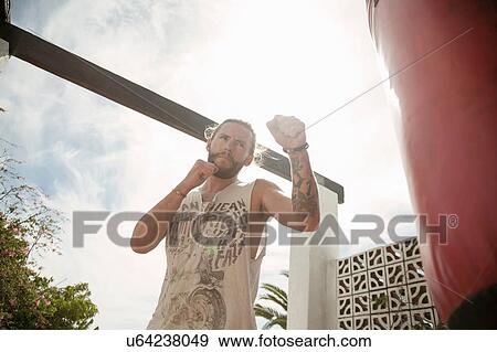 Stock Photo - Man practising kickboxing. Fotosearch