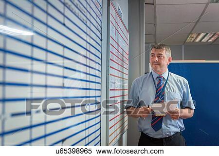 Manager presenting figures in meeting in engineering factory View Large Photo Image Stock Photography - Manager presenting figures in meeting in engineering factory. Fotosearch