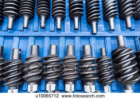 Stock Image - Master worm gears in engineering factory. Fotosearch