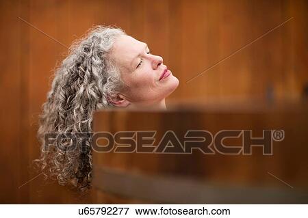 Mature woman resting on edge of hot tub at eco retreat View Large Photo Image Stock Photo - Mature woman resting on edge of hot tub at eco retreat. Fotosearch