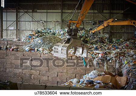 Mechanical grabber sorting out waste in depot View Large Photo Image Picture - Mechanical grabber sorting out waste in depot. Fotosearch