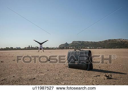 Mid adult businessman doing cartwheel on beach View Large Photo Image Stock Photo - Mid adult businessman doing cartwheel on beach. Fotosearch