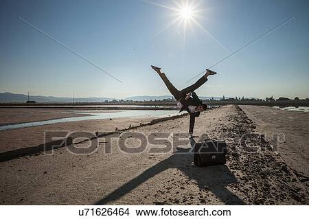 Mid adult businessman doing handstand on beach View Large Photo Image Picture - Mid adult businessman doing handstand on beach. Fotosearch