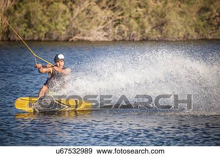 Mid adult man wakeboarding in sea, Cagliari, Sardinia, Italy View Large Photo Image Stock Photo - Mid adult man wakeboarding in sea, Cagliari, Sardinia, Italy. Fotosearch