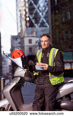 Motor scooter rider taking a sandwich break in London View Large Photo Image Stock Image - Motor scooter rider taking a sandwich break in London. Fotosearch