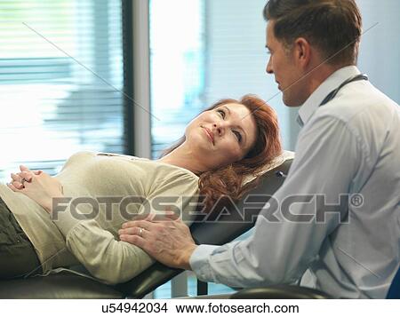 Orthopaedic consultant with patient in consulting room View Large Photo Image Picture - Orthopaedic consultant with patient in consulting room. Fotosearch