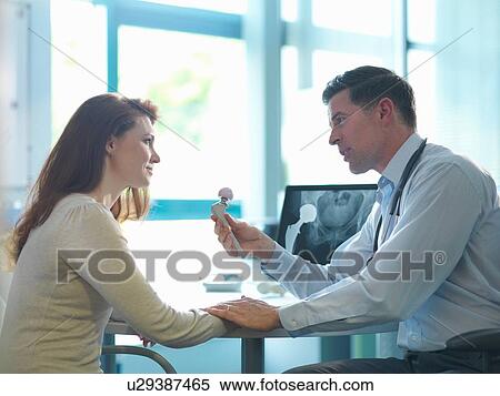 Stock Photography - Orthopaedic consultant with patient in consulting room. Fotosearch