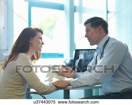 Stock Photography - Orthopaedic consultant with patient in consulting room. Fotosearch