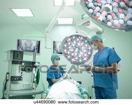 Orthopaedic surgeon and nurse preparing patient for hip surgery in operating theatre View Large Photo Image Stock Image - Orthopaedic surgeon and nurse preparing patient for hip surgery in operating theatre. Fotosearch