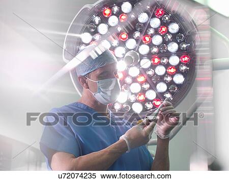 Orthopaedic surgeon in operating theatre with replacement hip stem View Large Photo Image Stock Photography - Orthopaedic surgeon in operating theatre with replacement hip stem. Fotosearch