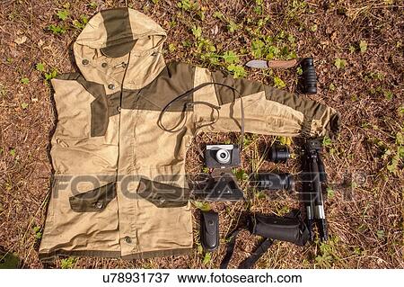 Overhead still life of camouflage anorak and photography equipment View Large Photo Image Stock Photo - Overhead still life of camouflage anorak and photography equipment. Fotosearch