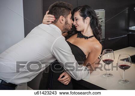 Passionate young couple kissing in kitchen View Large Photo Image Stock Image - Passionate young couple kissing in kitchen. Fotosearch