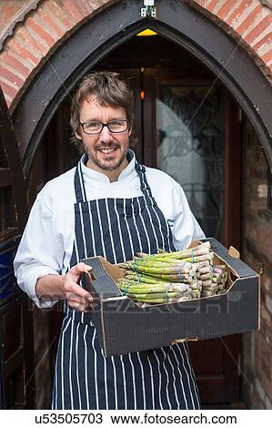 Portrait of chef holding box of asparagus View Large Photo Image Stock Image - Portrait of chef holding box of asparagus. Fotosearch