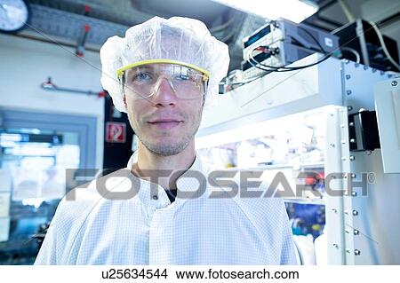 Picture - Portrait of male scientist in lab cleanroom. Fotosearch