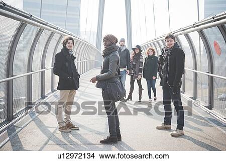 Picture - Portrait of six young adult friends on footbridge. Fotosearch