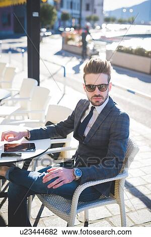 Portrait of stylish young businessman at sidewalk cafe View Large Photo Image Stock Image - Portrait of stylish young businessman at sidewalk cafe. Fotosearch