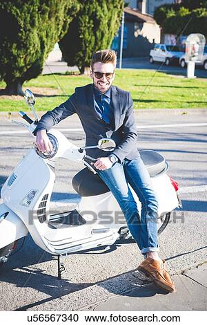 Portrait of stylish young man on moped View Large Photo Image Stock Image - Portrait of stylish young man on moped. Fotosearch