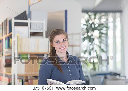 Portrait of young female student in library View Large Photo Image Stock Image - Portrait of young female student in library. Fotosearch