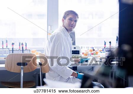 Stock Photography - Portrait of young male scientist at lab bench. Fotosearch