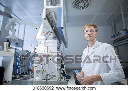 Portrait of young male scientist holding sample bottle in lab View Large Photo Image Stock Image - Portrait of young male scientist holding sample bottle in lab. Fotosearch