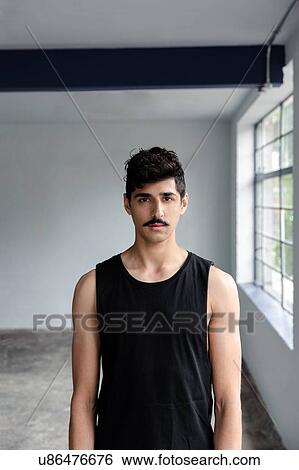 Stock Photograph - Portrait of young man in black. Fotosearch