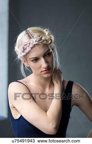Stock Image - Portrait of young woman with braided hair. Fotosearch