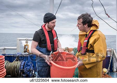 Research scientists and fisherman inspecting catch of fish on research ship View Large Photo Image Picture - Research scientists and fisherman inspecting catch of fish on research ship. Fotosearch