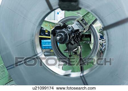 Rolls of steel in stamping machine in engineering factory, close up View Large Photo Image Picture - Rolls of steel in stamping machine in engineering factory, close up. Fotosearch