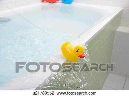 Rubber duck falling out of bath overflowing with water View Large Photo Image Stock Image - Rubber duck falling out of bath overflowing with water. Fotosearch