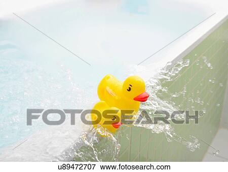 Rubber ducks falling out of bath overflowing with water View Large Photo Image Stock Photo - Rubber ducks falling out of bath overflowing with water. Fotosearch