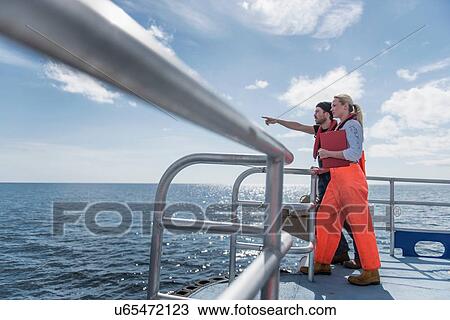 Scientists looking at wildlife on deck of research ship View Large Photo Image Stock Image - Scientists looking at wildlife on deck of research ship. Fotosearch