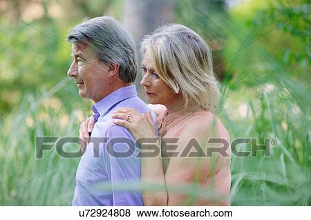 Senior couple standing together, outdoors, with pensive expression View Large Photo Image Stock Photo - Senior couple standing together, outdoors, with pensive expression. Fotosearch