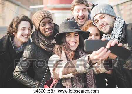 Six young adult friends taking selfie on smartphone View Large Photo Image Stock Photo - Six young adult friends taking selfie on smartphone. Fotosearch