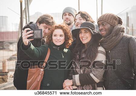 Six young adult friends taking smartphone selfie in city View Large Photo Image Stock Image - Six young adult friends taking smartphone selfie in city. Fotosearch