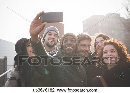 Six young adult friends taking smartphone selfie View Large Photo Image Stock Image - Six young adult friends taking smartphone selfie. Fotosearch