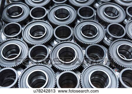 Stock Image - Steel gear wheels in production in engineering factory. Fotosearch