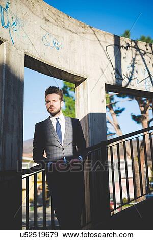Stylish young man with smartphone on footbridge stairway View Large Photo Image Stock Photo - Stylish young man with smartphone on footbridge stairway. Fotosearch