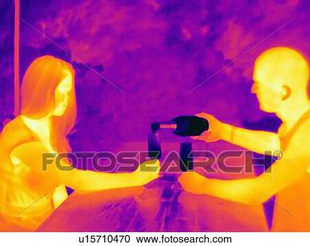Thermal photograph of young couple pouring wine at table View Large Photo Image Stock Image - Thermal photograph of young couple pouring wine at table. Fotosearch