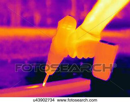 Thermal photograph of young mans hand using a hand drill View Large Photo Image Picture - Thermal photograph of young mans hand using a hand drill. Fotosearch