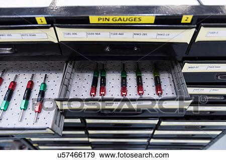 Stock Photo - Tools arranged in drawer in engineering factory, close up. Fotosearch