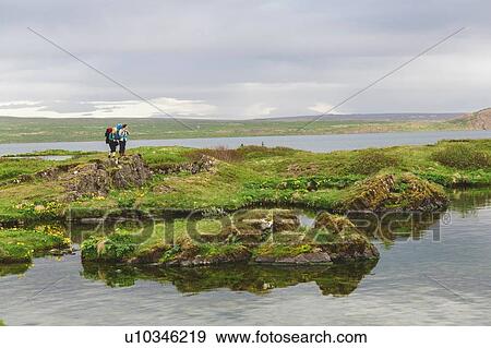 Two hikers hiking at lake, Thingvellir, Iceland View Large Photo Image Stock Photo - Two hikers hiking at lake, Thingvellir, Iceland. Fotosearch